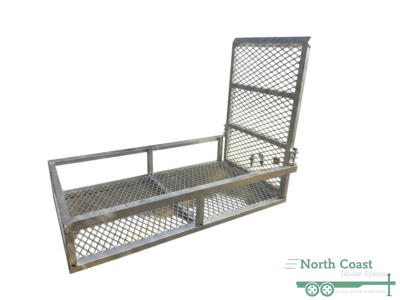 Close-up profile view of a hot-dipped galvanised steel trailer mower pad on a clean white background, highlighting the open mesh flooring, raised safety frame, and secure spring-loaded catch mechanism on the folded ramp.