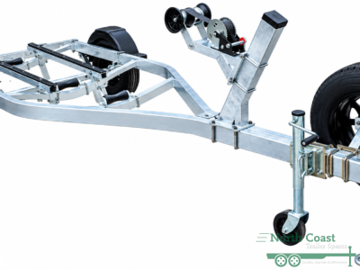 "Isolated studio view of an unbraked single axle aluminum boat trailer frame featuring an adjustable winch post, side-mounted spare tyre, black plastic mudguards, and custom black wheels."